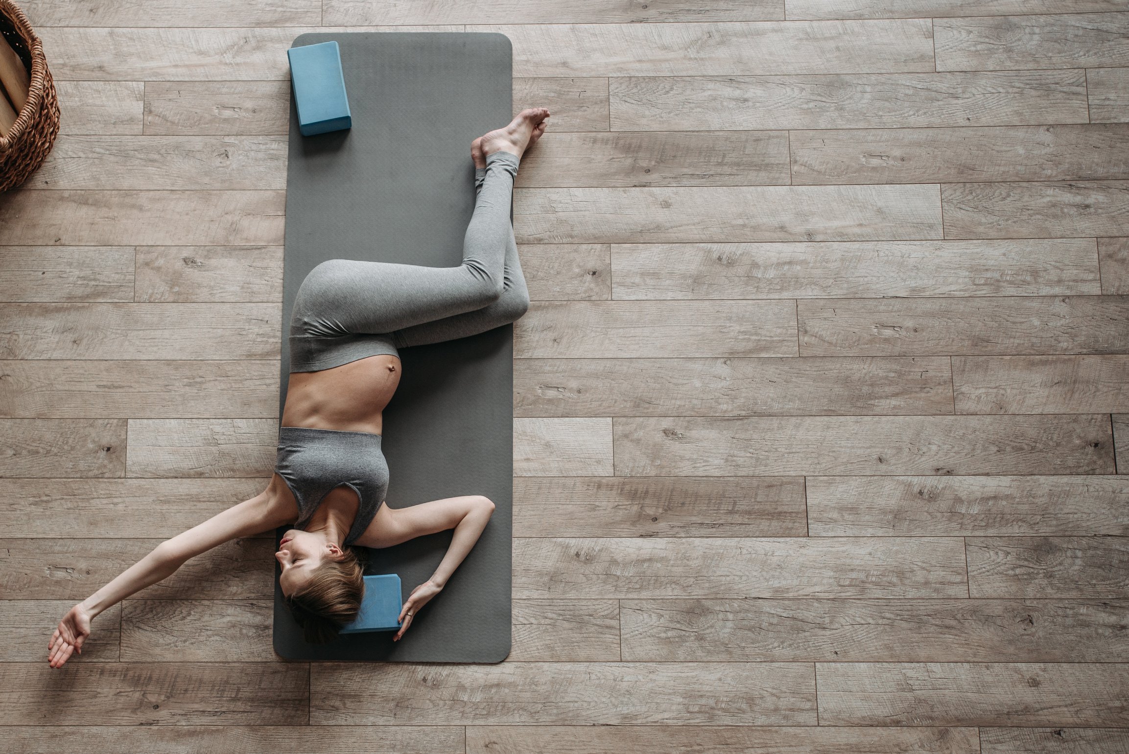 A Pregnant Woman in Gray Activewear Exercising at Home